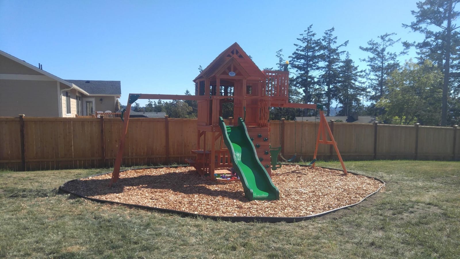 Backyard Discovery Skyfort II Cedar Wood Swing Set with Wave Slide, Raised Clubhouse, Crow's Nest, Monkey Bars, Balcony, Belt Swings, Trapeze, Rock Wall, Picnic Table, Sandbox, Ladder, Outdoor Playset customer photo 2